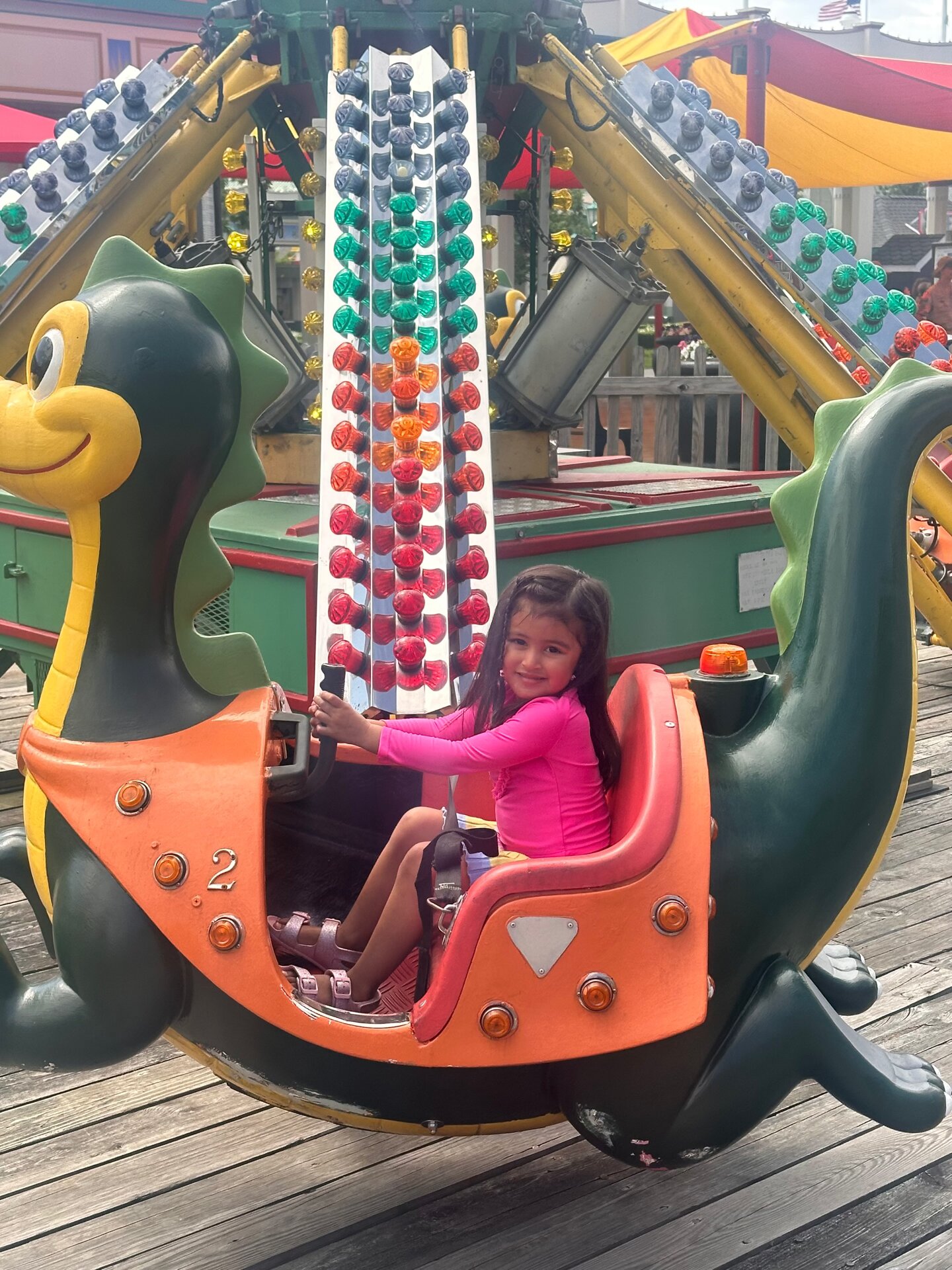 Little girl smiling on a dragon ride at Playland